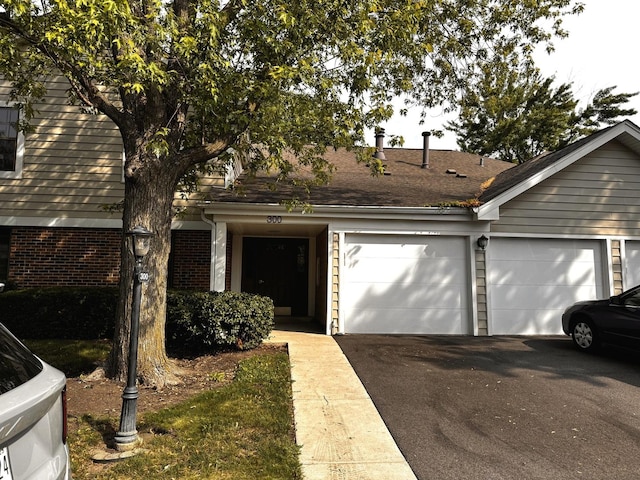 300 Pembridge Ln Unit D2, Schaumburg, IL 60193 - view of front of house featuring asphalt driveway and a garage