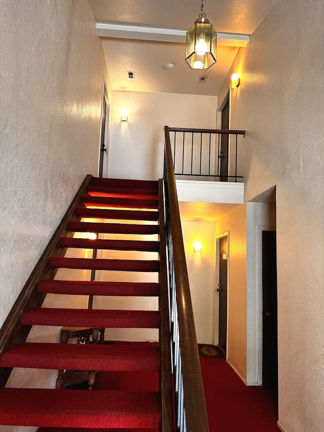 300 Pembridge Ln Unit D2, Schaumburg, IL 60193 - staircase featuring a textured wall and carpet