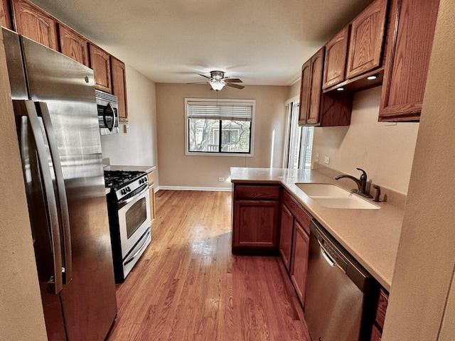 300 Pembridge Ln Unit D2, Schaumburg, IL 60193 - kitchen with appliances with stainless steel finishes, light wood-style flooring, light countertops, a ceiling fan, and brown cabinets