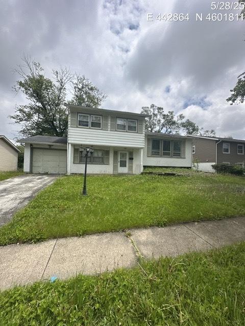 17807 Grandview Dr, Hazel Crest, IL 60429 - view of front facade with concrete driveway, a front yard, and a garage