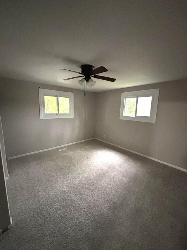 1403 Kings Rd, Carpentersville, IL 60110 - empty room featuring baseboards, carpet floors, and a ceiling fan