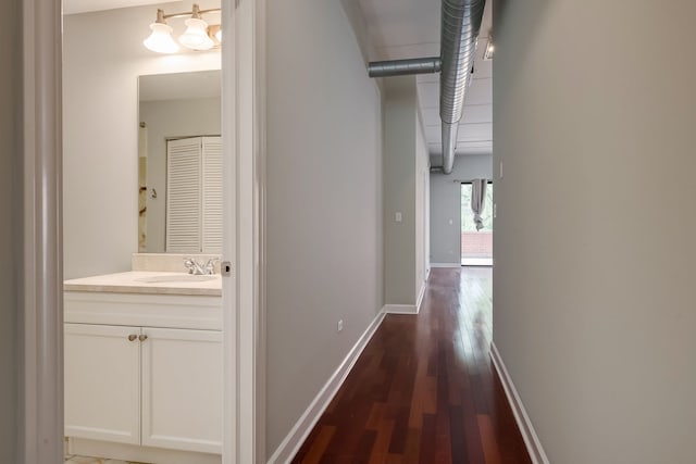 3125 W Fullerton Ave Unit 214, Chicago, IL 60647 - corridor with a sink and dark wood finished floors