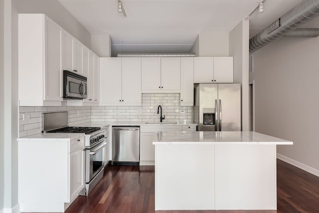 3125 W Fullerton Ave Unit 214, Chicago, IL 60647 - kitchen with stainless steel appliances, track lighting, and dark wood-type flooring