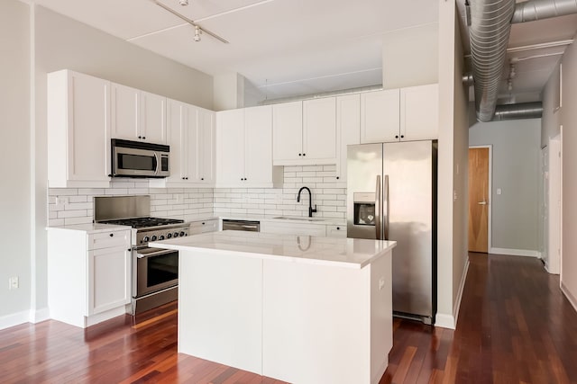 3125 W Fullerton Ave Unit 214, Chicago, IL 60647 - kitchen featuring stainless steel appliances, dark wood-style floors, decorative backsplash, and white cabinetry