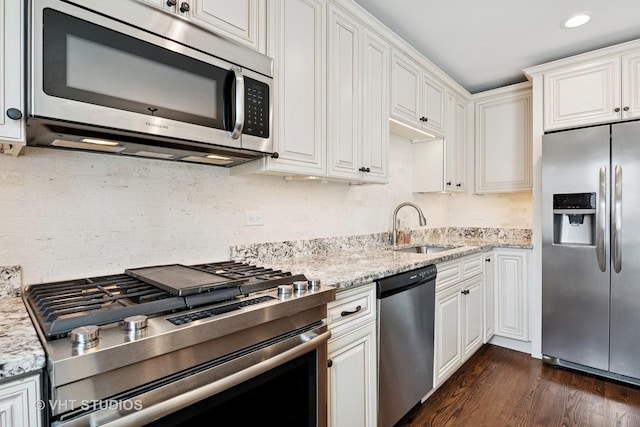 313 N Hale St, Wheaton, IL 60187 - kitchen featuring stainless steel appliances, white cabinetry, dark wood-style flooring, tasteful backsplash, and light stone counters