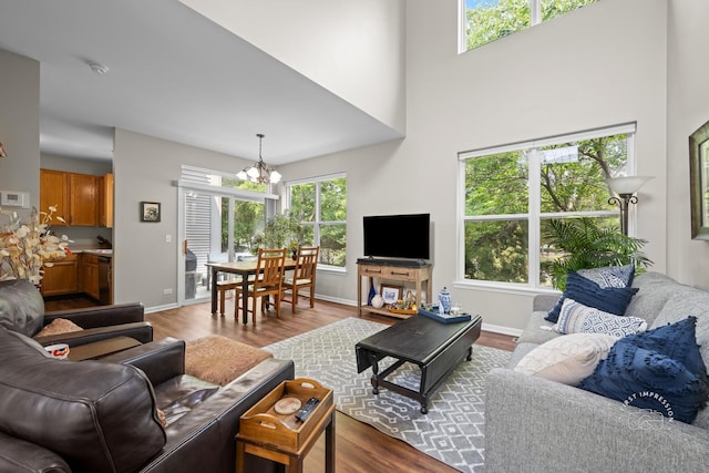2049 Sunrise Cir, Aurora, IL 60503 - living room featuring a chandelier, dark wood-style flooring, and a high ceiling