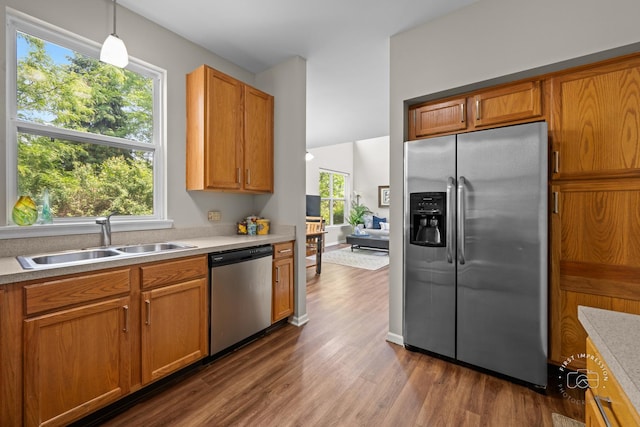 2049 Sunrise Cir, Aurora, IL 60503 - kitchen with appliances with stainless steel finishes, dark wood-type flooring, light countertops, and decorative light fixtures