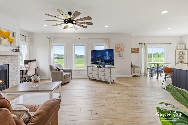 1405 Navajo Ct, Kankakee, IL 60901 - living room featuring a glass covered fireplace, light wood finished floors, baseboards, a ceiling fan, and recessed lighting