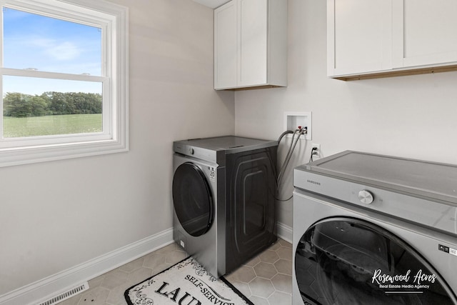 1405 Navajo Ct, Kankakee, IL 60901 - laundry area with washer and dryer, cabinet space, and baseboards
