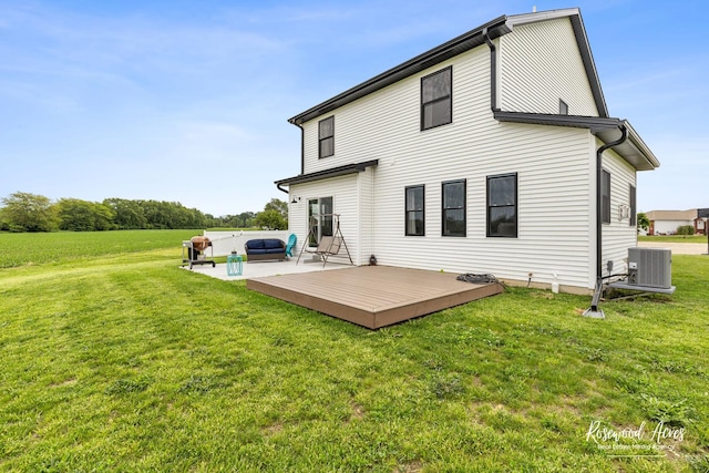 1405 Navajo Ct, Kankakee, IL 60901 - rear view of property featuring central AC unit, a wooden deck, a lawn, and an outdoor hangout area