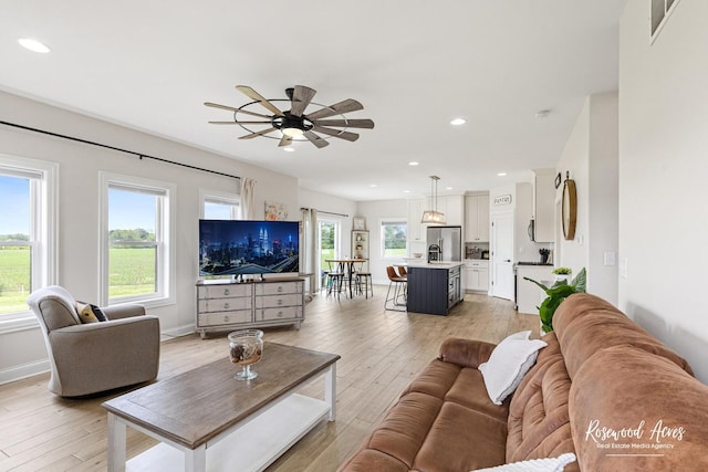 1405 Navajo Ct, Kankakee, IL 60901 - living area with light wood finished floors, plenty of natural light, ceiling fan, recessed lighting, and baseboards