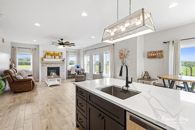 1405 Navajo Ct, Kankakee, IL 60901 - kitchen with a sink, ceiling fan, light wood finished floors, a stone fireplace, and recessed lighting