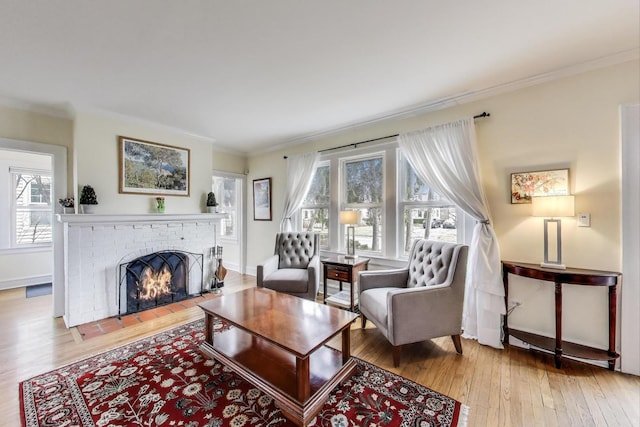 1314 Saint Johns Ave, Highland Park, IL 60035 - living room featuring ornamental molding, wood finished floors, a brick fireplace, healthy amount of natural light, and baseboards