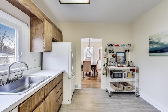 1314 Saint Johns Ave, Highland Park, IL 60035 - kitchen with a sink, brown cabinets, and freestanding refrigerator
