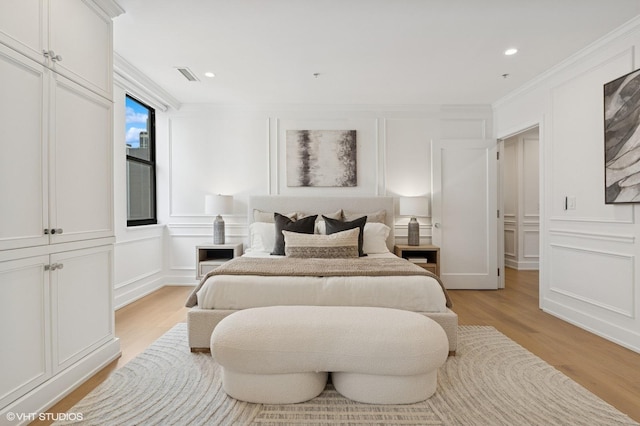 1155 N Dearborn St Unit 1301, Chicago, IL 60610 - bedroom with a decorative wall, light wood-type flooring, ornamental molding, and recessed lighting