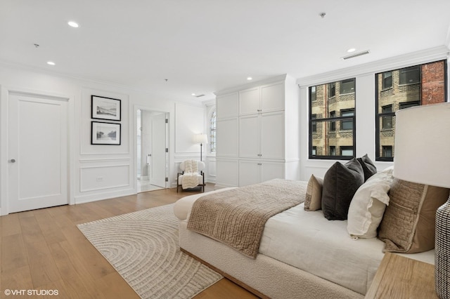 1155 N Dearborn St Unit 1301, Chicago, IL 60610 - bedroom featuring light wood finished floors, ornamental molding, a decorative wall, recessed lighting, and a closet