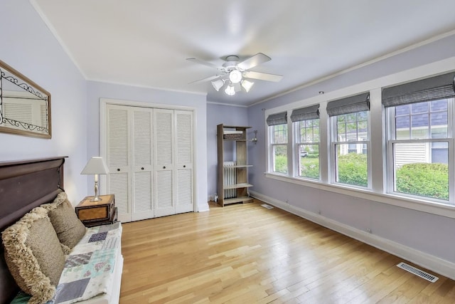 1350 Saint Johns Ave, Highland Park, IL 60035 - bedroom featuring hardwood / wood-style floors, baseboards, a closet, crown molding, and ceiling fan