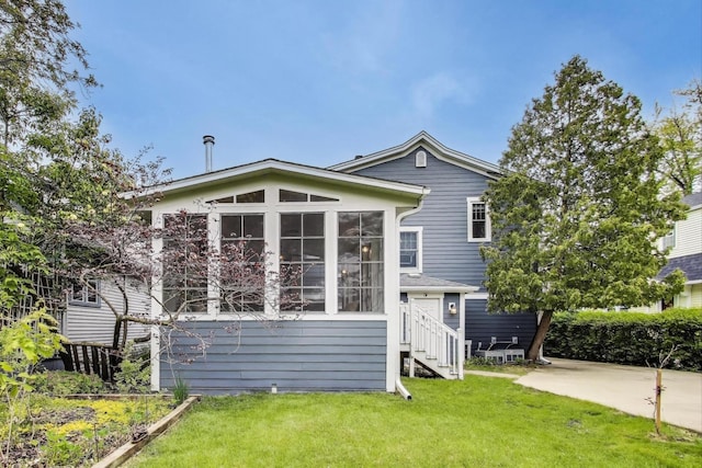 1350 Saint Johns Ave, Highland Park, IL 60035 - rear view of house with a lawn and a sunroom