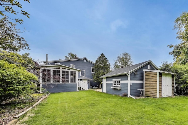1350 Saint Johns Ave, Highland Park, IL 60035 - back of property with a sunroom, a lawn, and an outdoor structure
