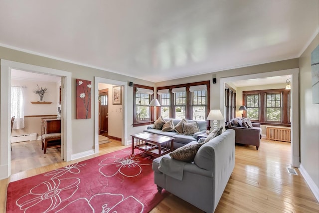 1350 Saint Johns Ave, Highland Park, IL 60035 - living room with radiator heating unit, a baseboard heating unit, light wood-type flooring, ornamental molding, and baseboards