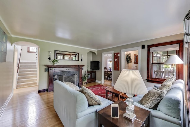 1350 Saint Johns Ave, Highland Park, IL 60035 - living area featuring arched walkways, stairway, baseboards, a glass covered fireplace, and ornamental molding