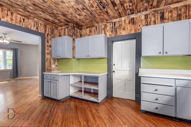 455 Sylvan Ave, Grand Ridge, IL 61325 - kitchen with backsplash, light countertops, gray cabinetry, wooden ceiling, and wood walls