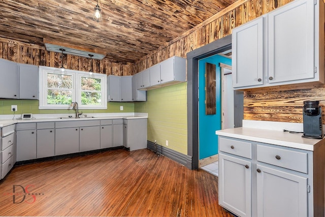 455 Sylvan Ave, Grand Ridge, IL 61325 - kitchen featuring a sink, wood ceiling, light countertops, dark wood finished floors, and baseboards
