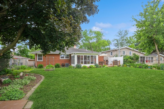 430 Florian Dr, Des Plaines, IL 60016 - back of property with a sunroom, brick siding, and a chimney