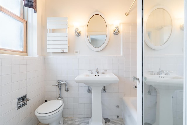 5000 S Cornell Ave Unit 3A, Chicago, IL 60615 - bathroom featuring tile walls, wainscoting, shower / bathtub combination, and tile patterned flooring