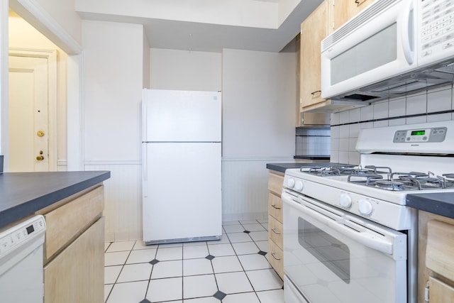 5000 S Cornell Ave Unit 3A, Chicago, IL 60615 - kitchen featuring white appliances, dark countertops, wainscoting, and light brown cabinetry