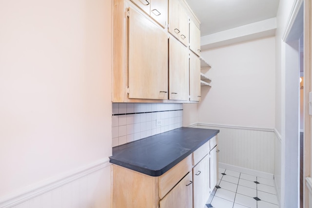 5000 S Cornell Ave Unit 3A, Chicago, IL 60615 - kitchen featuring dark countertops, wainscoting, light tile patterned flooring, light brown cabinetry, and tasteful backsplash