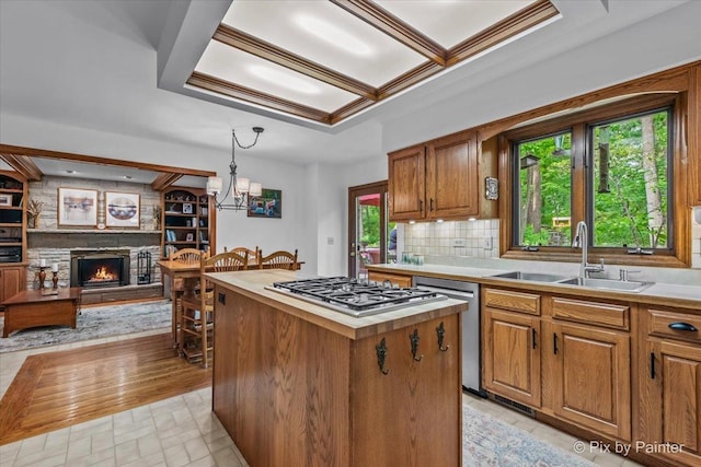 5N538 Hidden Springs Dr, Saint Charles, IL 60175 - kitchen with appliances with stainless steel finishes, a center island, a fireplace, and light countertops