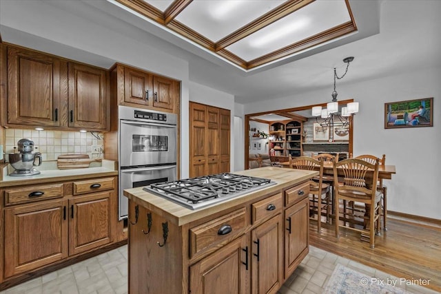 5N538 Hidden Springs Dr, Saint Charles, IL 60175 - kitchen with appliances with stainless steel finishes, wooden counters, tasteful backsplash, and pendant lighting