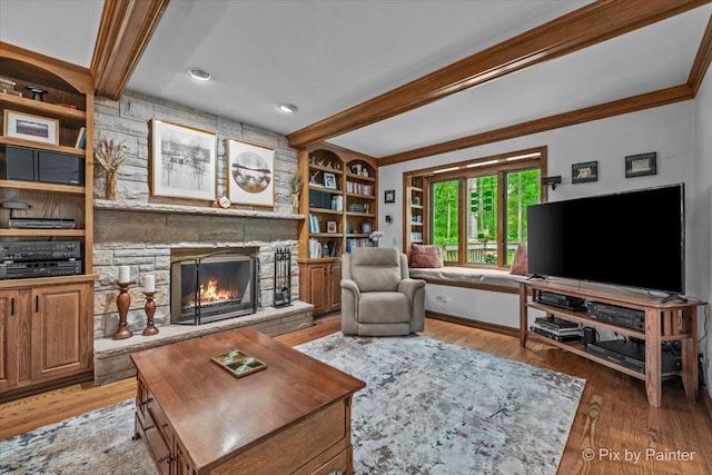 5N538 Hidden Springs Dr, Saint Charles, IL 60175 - living room featuring beamed ceiling, a stone fireplace, light wood-style flooring, crown molding, and built in shelves