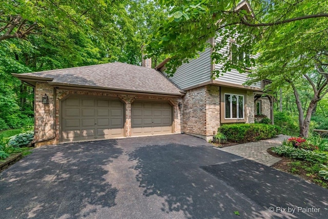 5N538 Hidden Springs Dr, Saint Charles, IL 60175 - view of front of home with asphalt driveway, brick siding, an attached garage, and a chimney