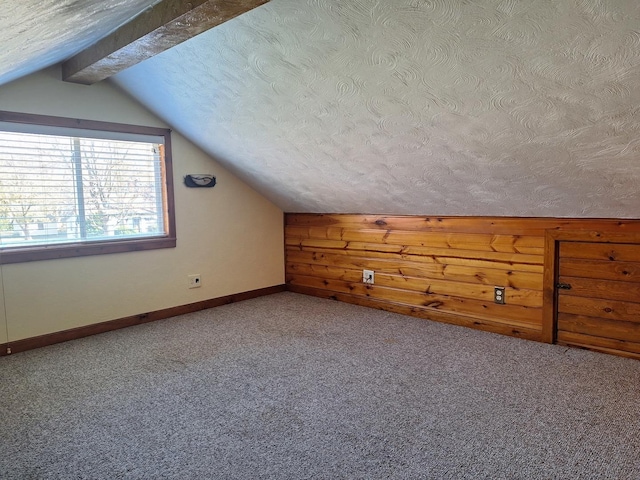 306 N Joy St, Tampico, IL 61283 - additional living space with lofted ceiling, a textured ceiling, carpet flooring, and baseboards