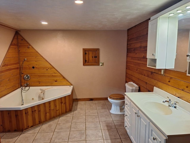 306 N Joy St, Tampico, IL 61283 - full bathroom with wooden walls, a jetted tub, vanity, toilet, and tile patterned flooring