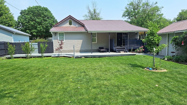 306 N Joy St, Tampico, IL 61283 - rear view of house with metal roof and a deck