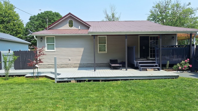 306 N Joy St, Tampico, IL 61283 - rear view of house featuring metal roof, a lawn, and a wooden deck