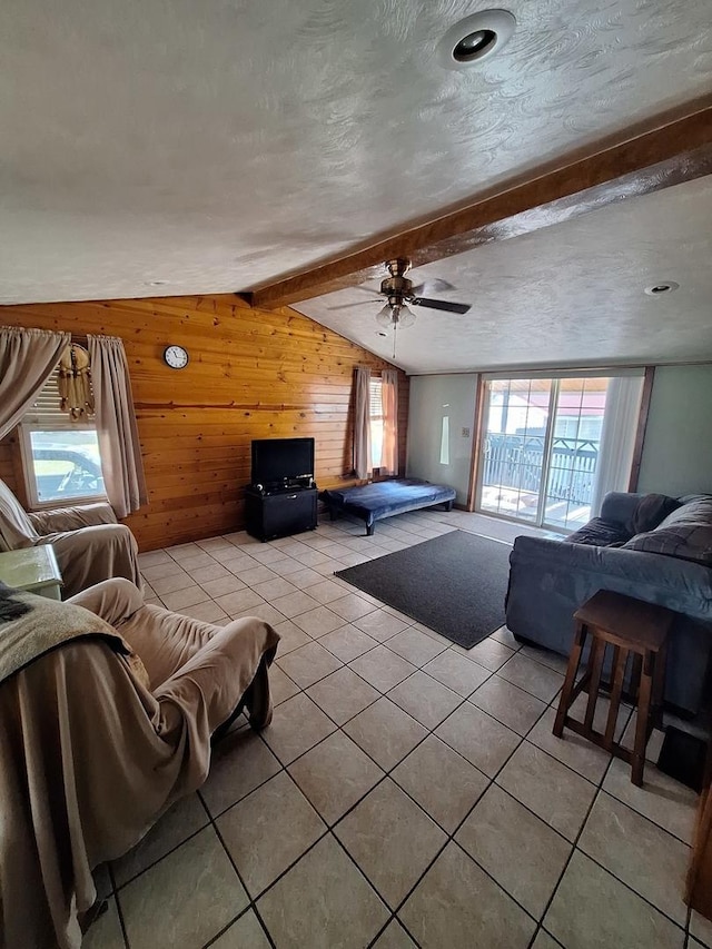 306 N Joy St, Tampico, IL 61283 - living area with wooden walls, light tile patterned floors, and a ceiling fan