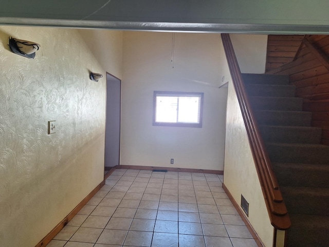 306 N Joy St, Tampico, IL 61283 - spare room with stairs, light tile patterned floors, and baseboards