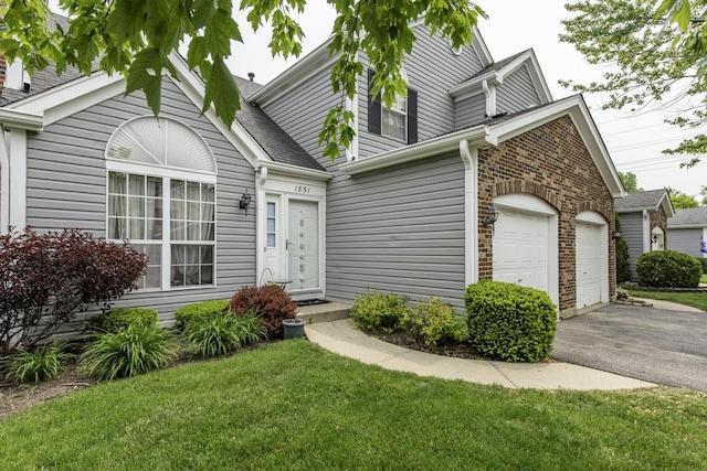 1851 Salem Ct, Gurnee, IL 60031 - view of front facade with asphalt driveway, a front yard, and a shingled roof