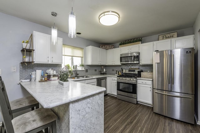 1851 Salem Ct, Gurnee, IL 60031 - kitchen with appliances with stainless steel finishes, a sink, a peninsula, white cabinets, and light countertops