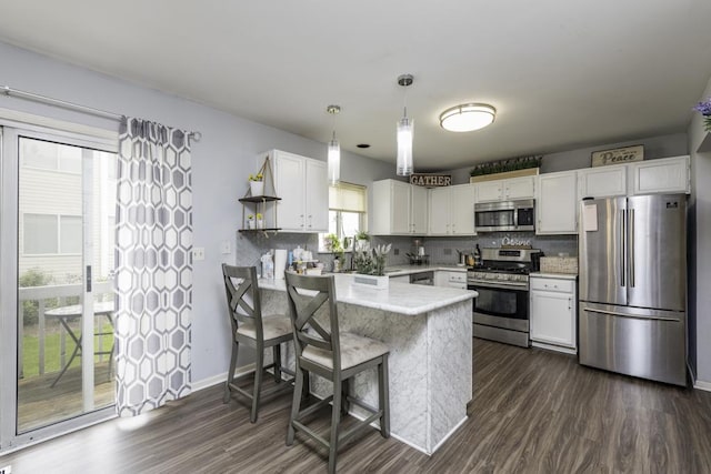 1851 Salem Ct, Gurnee, IL 60031 - kitchen with stainless steel appliances, a peninsula, white cabinets, and tasteful backsplash