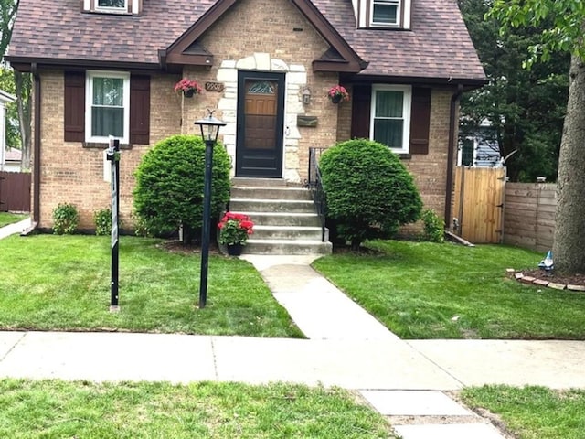 9907 Kedvale Ave, Skokie, IL 60076 - view of front facade featuring brick siding and a shingled roof