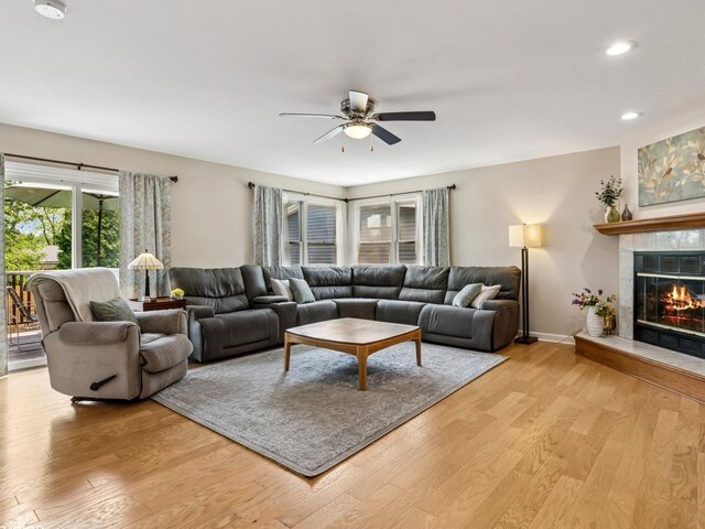 9907 Kedvale Ave, Skokie, IL 60076 - living room featuring ceiling fan, light wood-type flooring, a tile fireplace, and recessed lighting