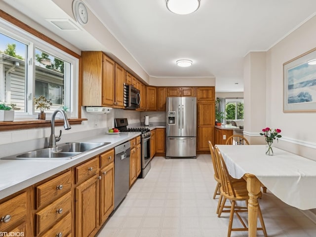 9907 Kedvale Ave, Skokie, IL 60076 - kitchen with appliances with stainless steel finishes, brown cabinetry, light flooring, and light countertops
