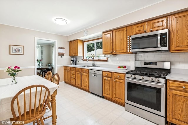 9907 Kedvale Ave, Skokie, IL 60076 - kitchen featuring stainless steel appliances, light floors, light countertops, and brown cabinetry
