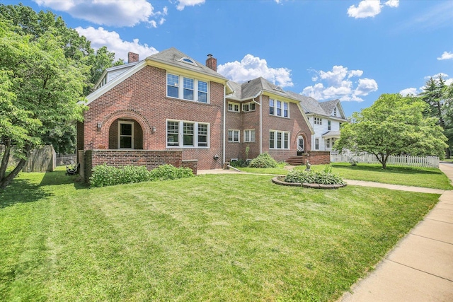 310 Davidson Dr, Champaign, IL 61821 - view of front facade with brick siding and a chimney