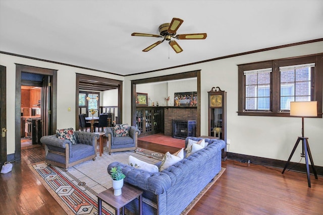 310 Davidson Dr, Champaign, IL 61821 - living area with wood finished floors, ornamental molding, ceiling fan, and a brick fireplace